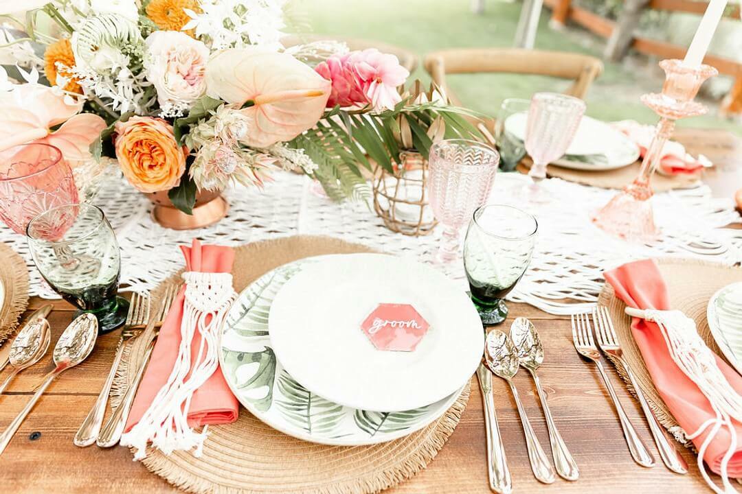 Tropical boho table setting with pink floral centerpiece | Wedding Checklist by Here Comes The Guide